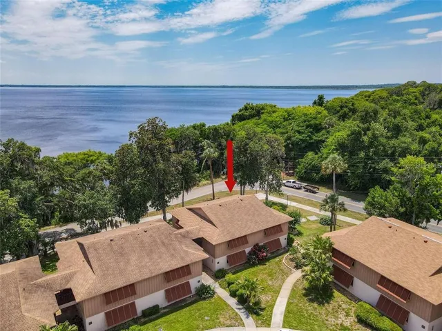 a view of a house with backyard and deck