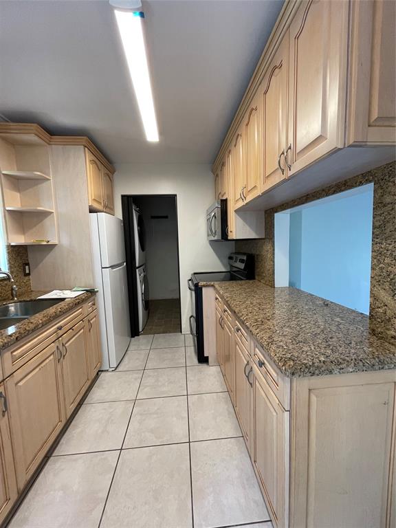 6101 Northwest 18th Street Margate, FL 33063 - Photo 12 of 22 a kitchen with stainless steel appliances granite countertop a stove a sink and a refrigerator