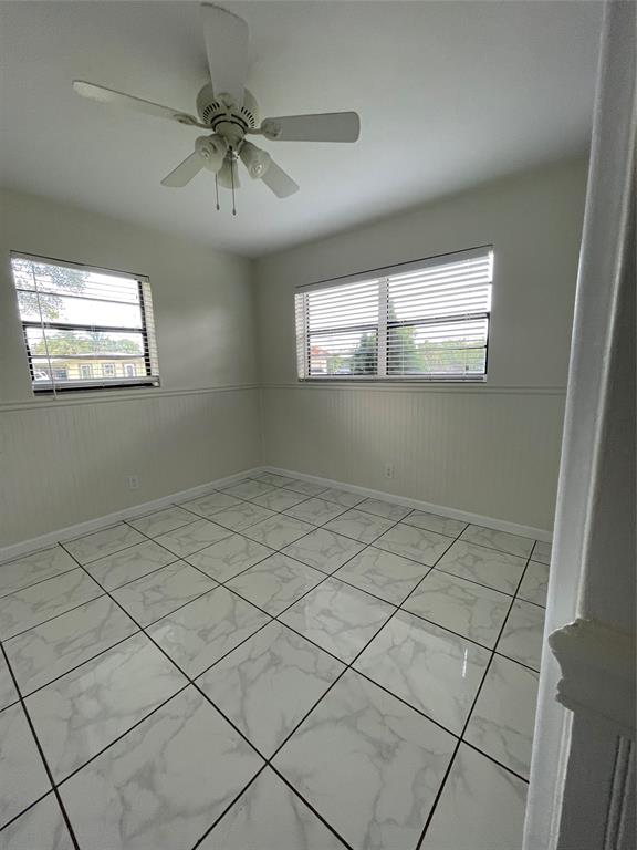 6101 Northwest 18th Street Margate, FL 33063 - Photo 18 of 22 a view of room with window and chandelier fan