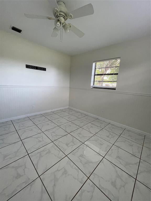 6101 Northwest 18th Street Margate, FL 33063 - Photo 19 of 22 an empty room with windows and fan