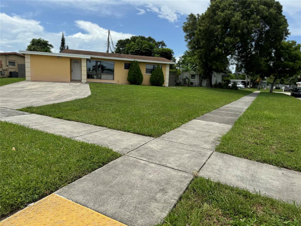 6101 Northwest 18th Street Margate, FL 33063 - Photo 2 of 22 front view of a house with a yard