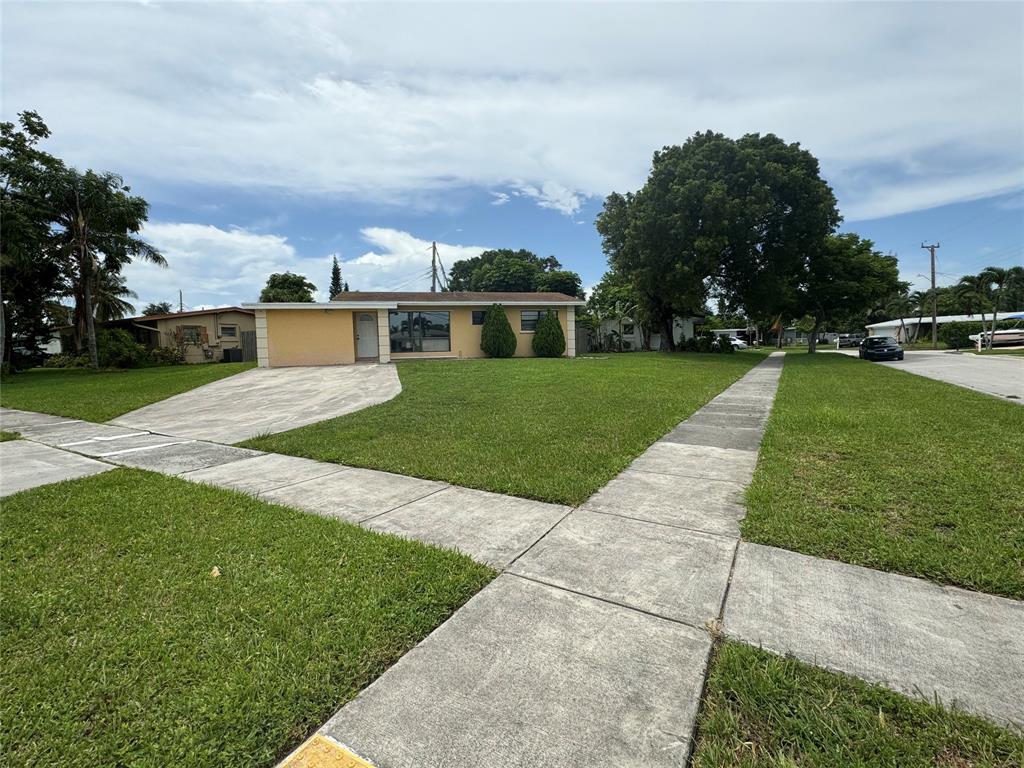 6101 Northwest 18th Street Margate, FL 33063 - Photo 3 of 22 a view of a house with a yard