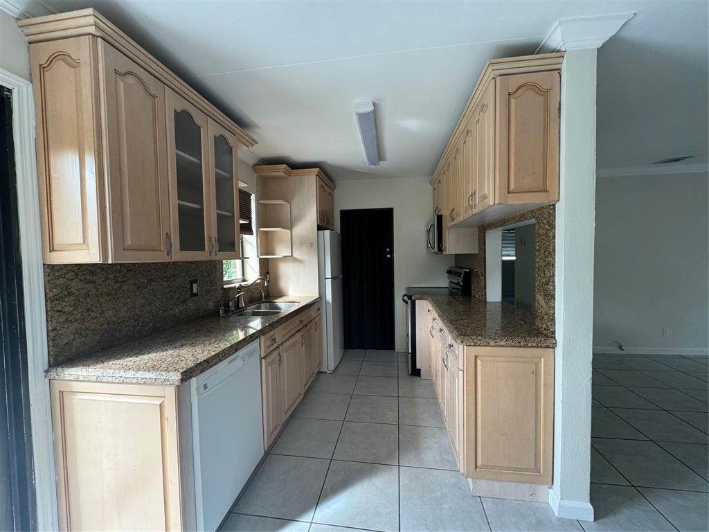 6101 Northwest 18th Street Margate, FL 33063 - Photo 10 of 22 a kitchen with stainless steel appliances granite countertop a refrigerator and a sink