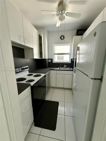 a kitchen with stainless steel appliances a refrigerator sink and microwave