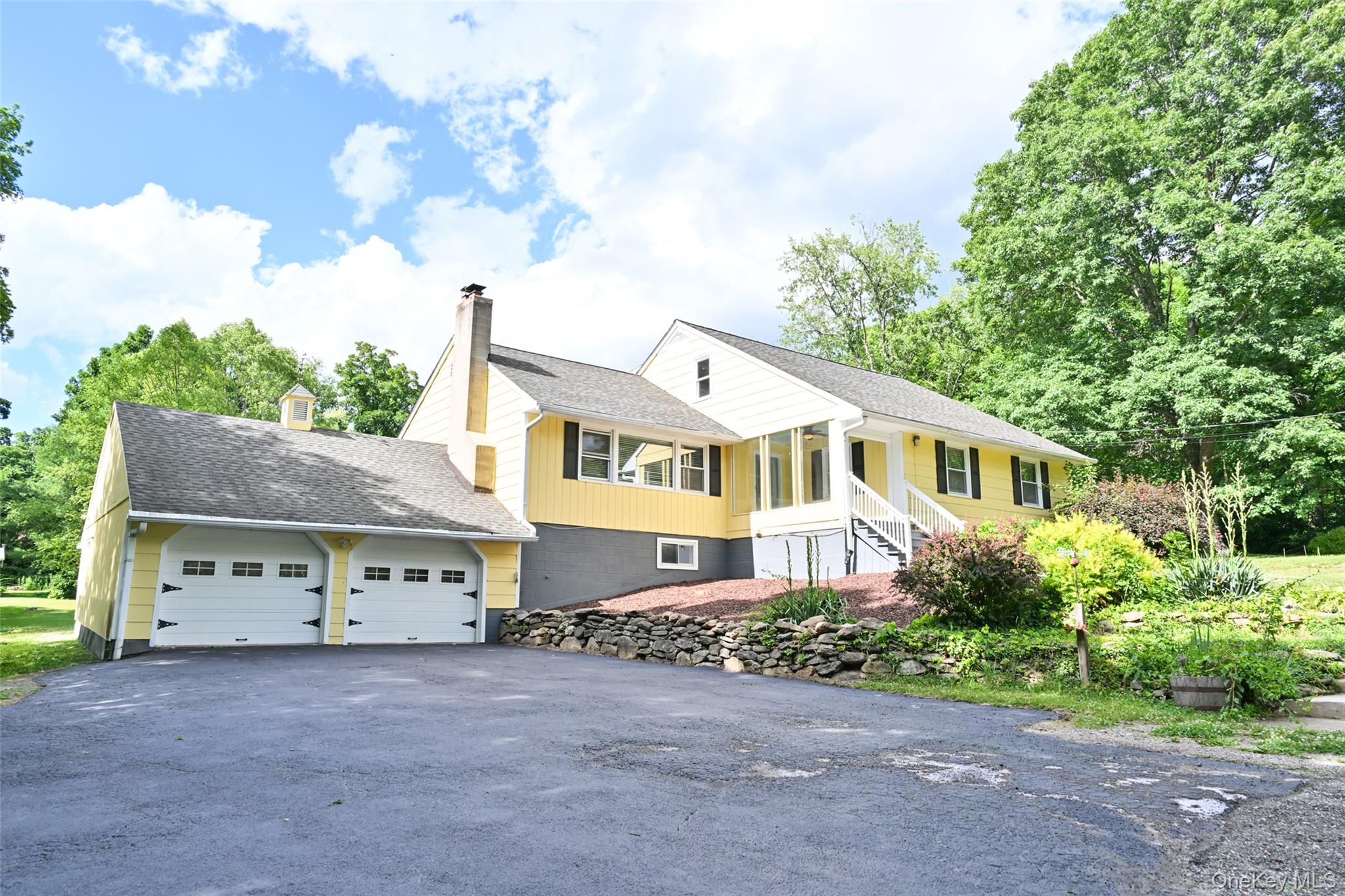 136 Foggintown Road Brewster, NY 10509 - Photo 3 of 50 a front view of a house with a garden