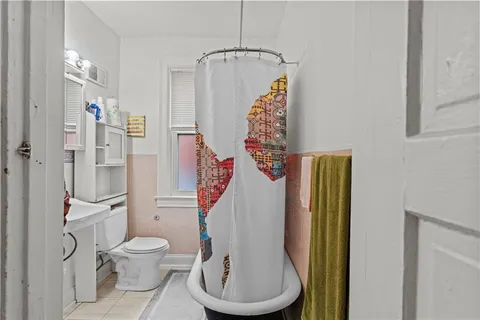 a bathroom with a toilet and a shower