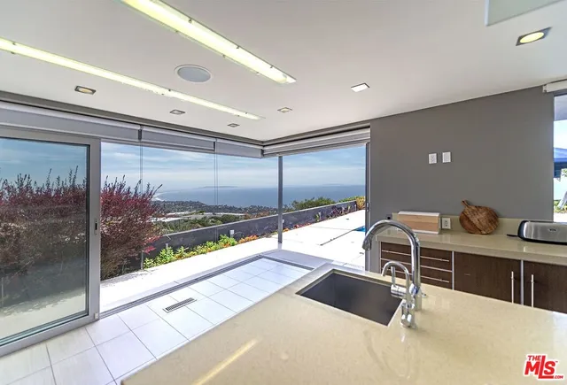 a kitchen with stainless steel appliances granite countertop a sink and a refrigerator
