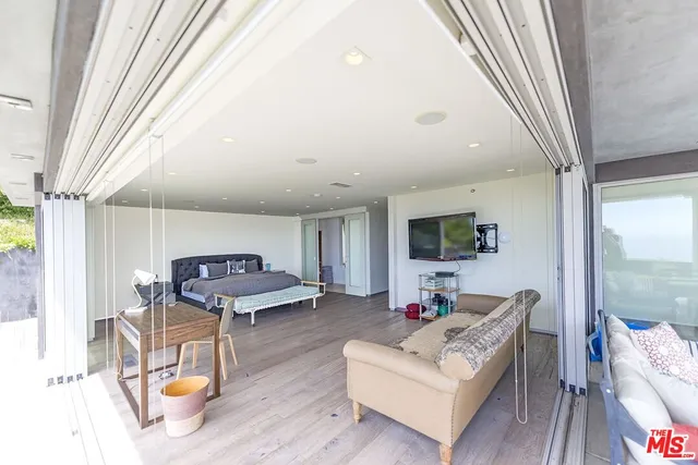 a bathroom with a bath tub a mirror and a shower
