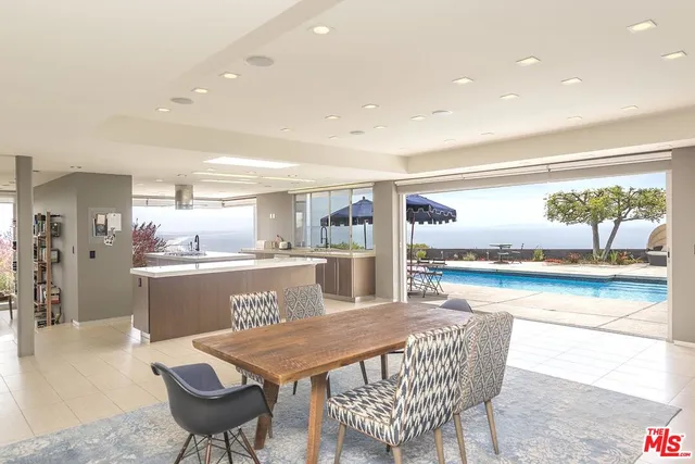 a outdoor dining space with furniture and view of kitchen