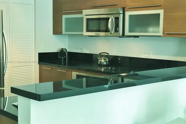 a kitchen with a sink and a microwave