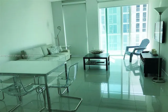 a living room with furniture and a floor to ceiling window