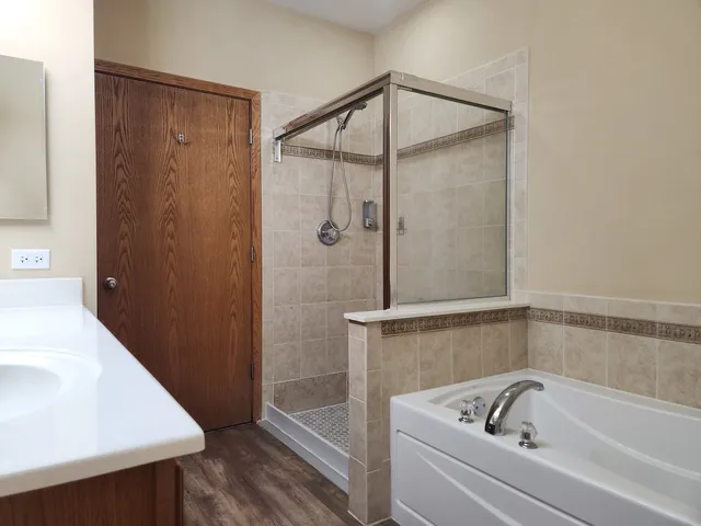 a bathroom with a bathtub and shower