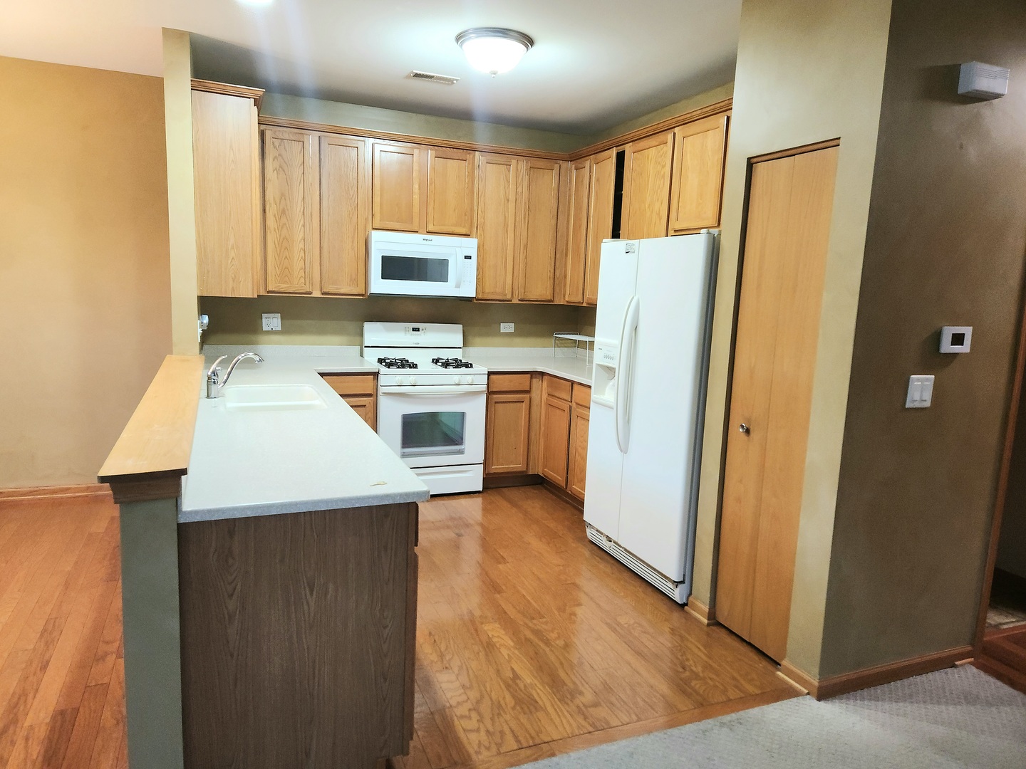 1547 Millbrook Drive Algonquin, IL 60102 - Photo 6 of 17 a kitchen with stainless steel appliances a refrigerator a stove a sink a center island and furniture