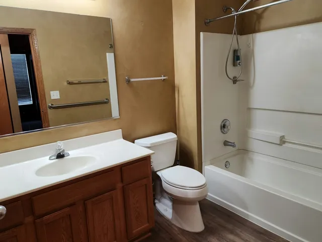 a bathroom with a sink a toilet and shower