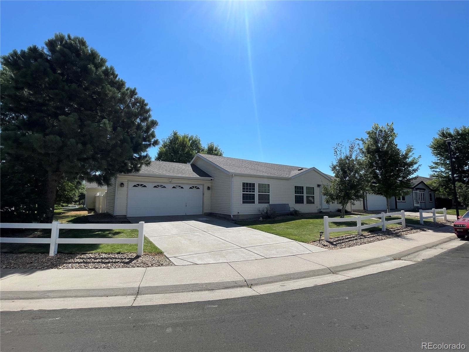 a view of pool with lawn chairs and plants