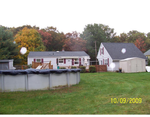 68 Fair Oak Road Springfield, MA 01128 - Photo 9 of 26 a view of a house with a big yard and large trees