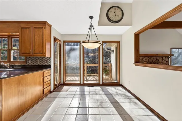 a view of an entryway with wooden floor fireplace and windows