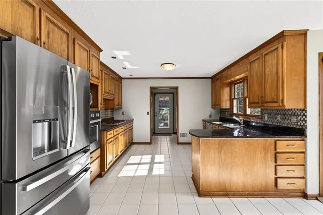 a view of a big room with wooden floor stairs and windows
