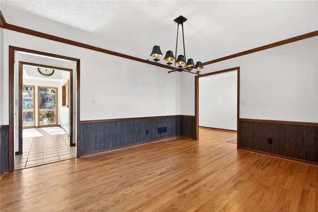 a large kitchen with stainless steel appliances a stove a sink dishwasher and cabinets with wooden floor