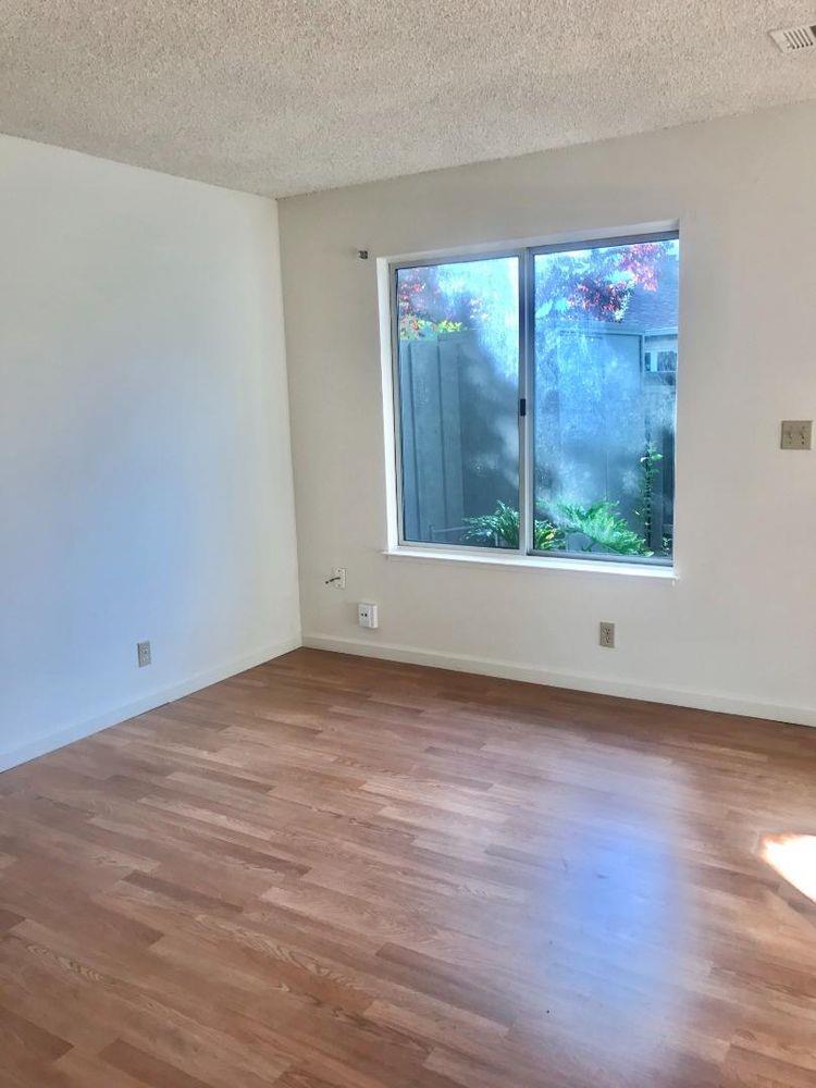 4685 Persimmon Place San Jose, CA 95129 - Photo 5 of 13 a view of an empty room with wooden floor and a window