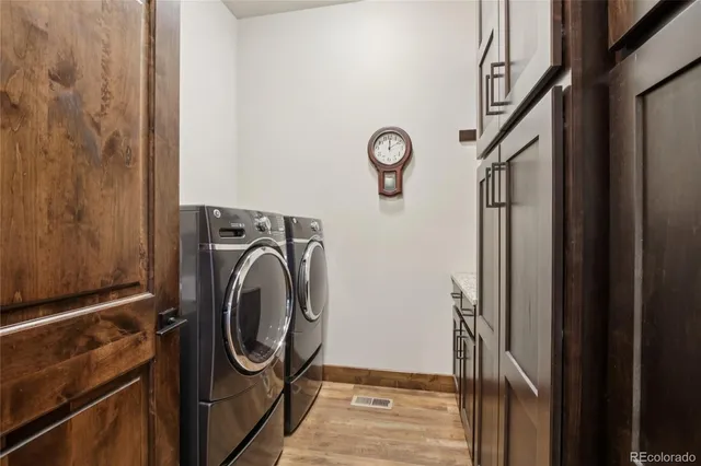 a view of a room with furniture and wooden floor