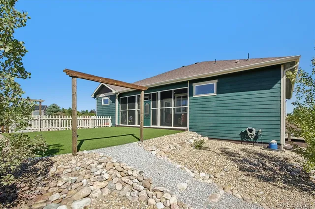 a view of a house with a yard and sitting area