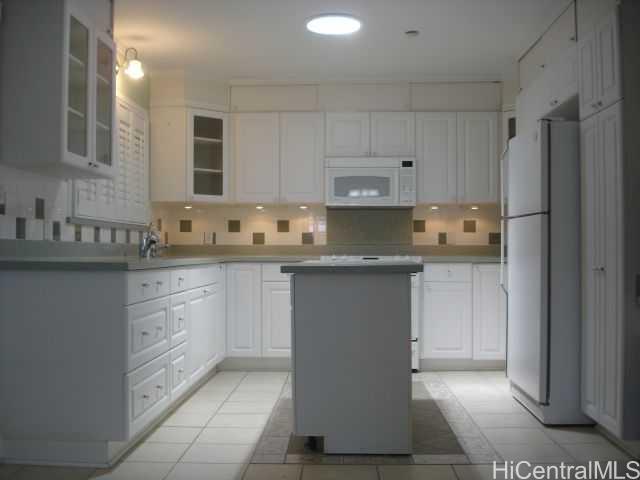5340 Malu Place Honolulu, HI 96816 - Photo 1 of 1 a kitchen with kitchen island granite countertop white cabinets and stainless steel appliances