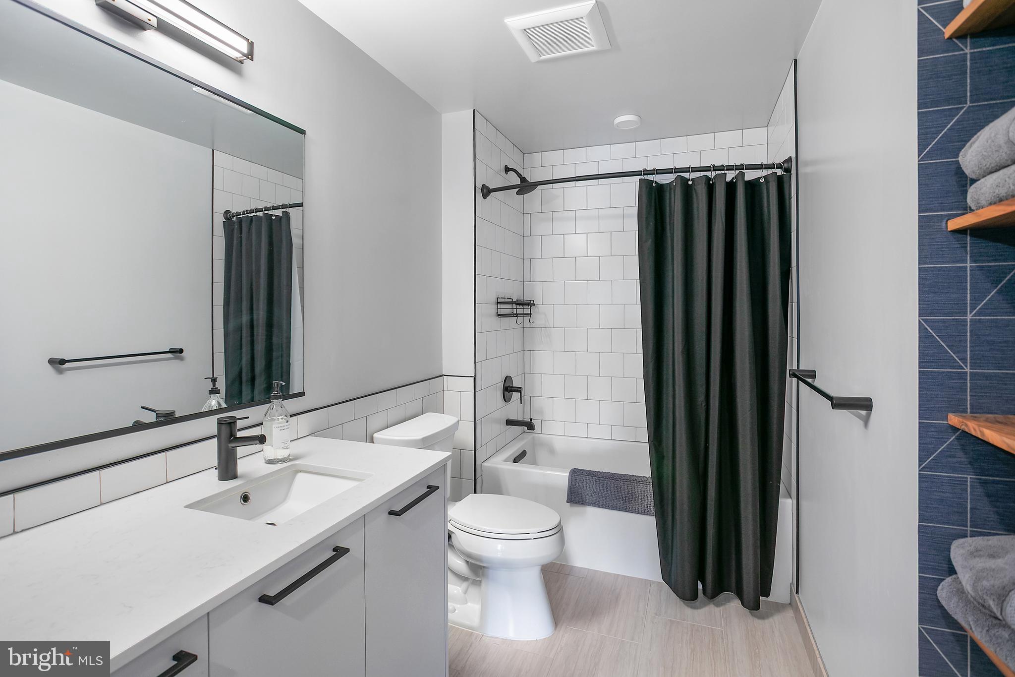 1625 Eckington Place Northeast, Unit 421 Washington, DC 20002 - Photo 15 of 40 a bathroom with a sink toilet and shower