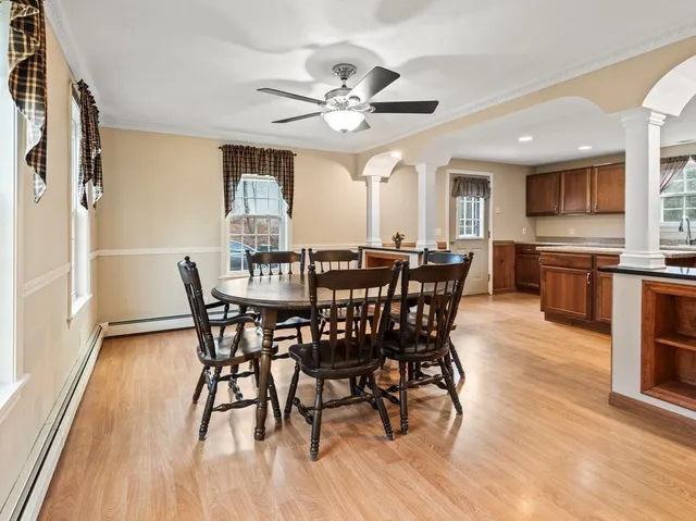 a view of a dining room with furniture window and wooden floor