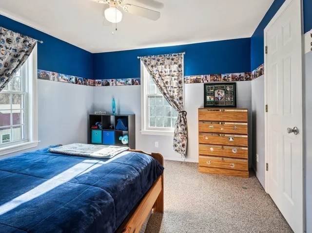 a bedroom with a bed dresser and a window