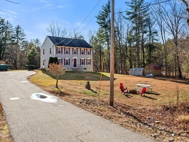 a view of a house with snow on the road