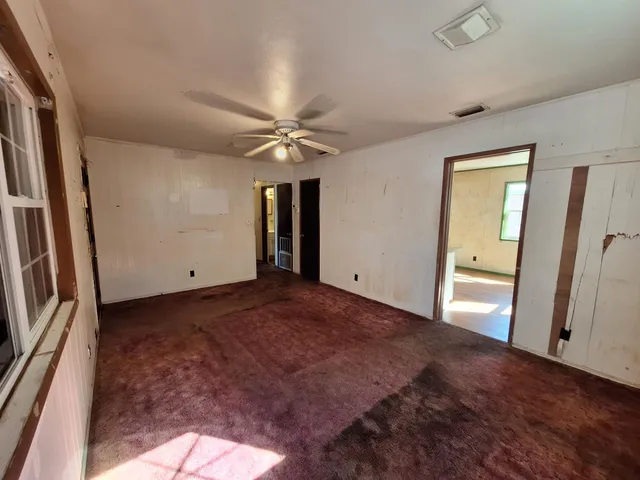 a kitchen with granite countertop a stove a sink and a refrigerator