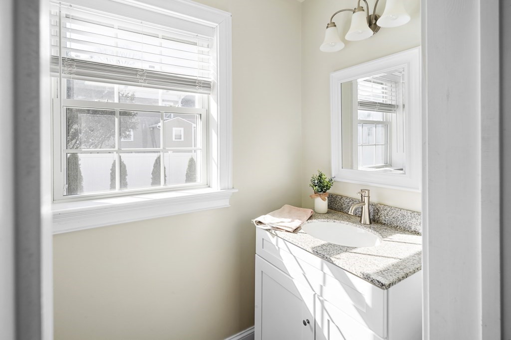 2 Willow Avenue Danvers, MA 01923 - Photo 12 of 42 a bathroom with a granite countertop sink and a mirror