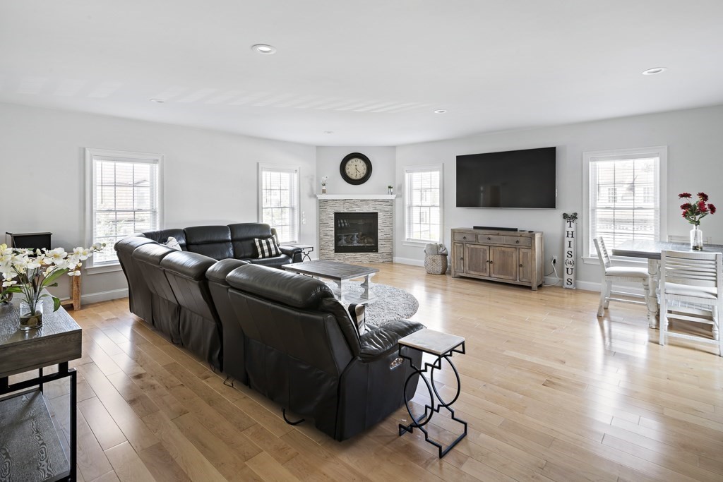 2 Willow Avenue Danvers, MA 01923 - Photo 15 of 42 a living room with furniture a flat screen tv and a fireplace
