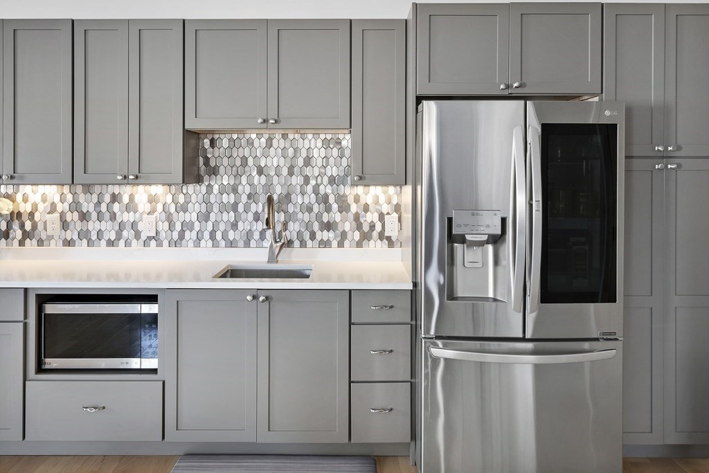 2 Willow Avenue Danvers, MA 01923 - Photo 19 of 42 a kitchen with stainless steel appliances white cabinets and a sink