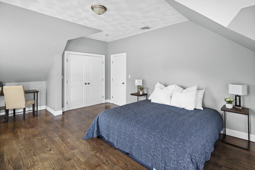 2 Willow Avenue Danvers, MA 01923 - Photo 24 of 42 a large bedroom with a bed and table chair