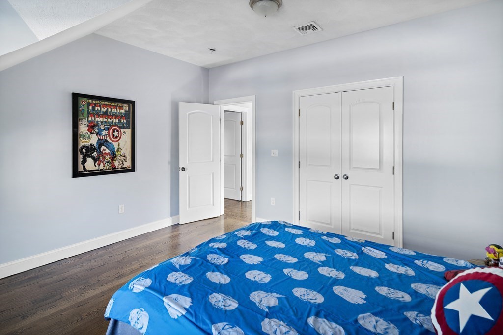 2 Willow Avenue Danvers, MA 01923 - Photo 27 of 42 a bedroom with a bed and painting on the wall