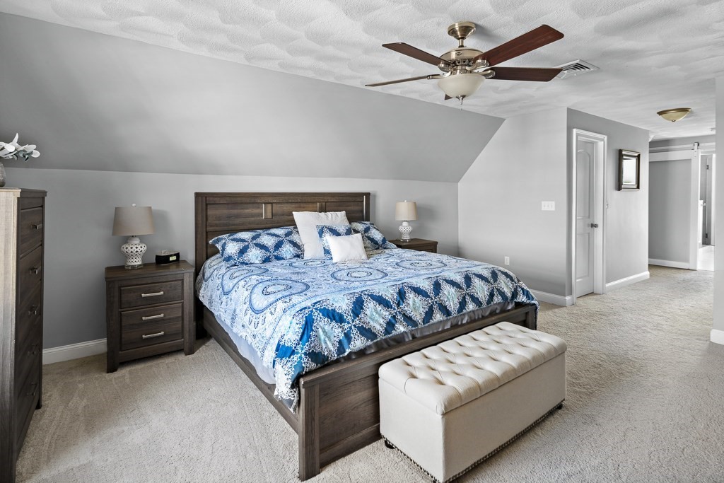 2 Willow Avenue Danvers, MA 01923 - Photo 30 of 42 a bedroom with a bed and ceiling fan