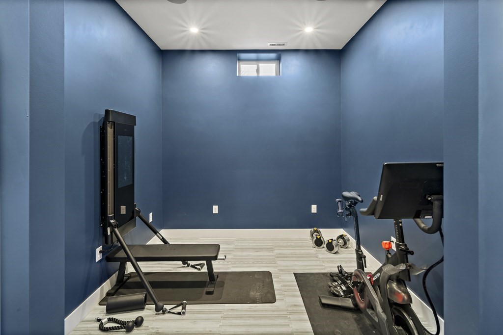 2 Willow Avenue Danvers, MA 01923 - Photo 36 of 42 a room with gym equipment and a flat screen tv