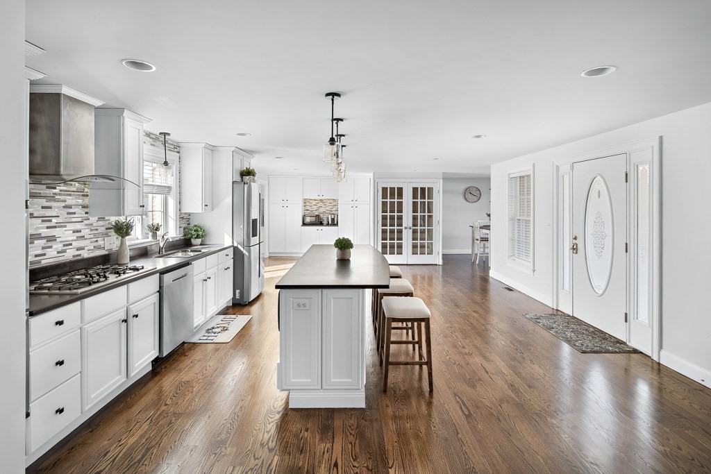 2 Willow Avenue Danvers, MA 01923 - Photo 4 of 42 a large kitchen with cabinets wooden floor and stainless steel appliances