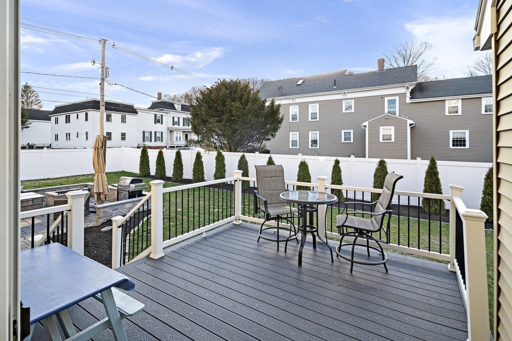 2 Willow Avenue Danvers, MA 01923 - Photo 41 of 42 a view of a roof deck with table and chairs floor to ceiling window with wooden floor