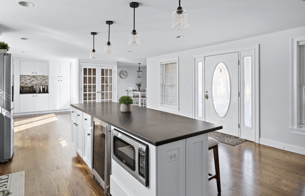 2 Willow Avenue Danvers, MA 01923 - Photo 7 of 42 a kitchen with stainless steel appliances granite countertop a stove a sink and a refrigerator
