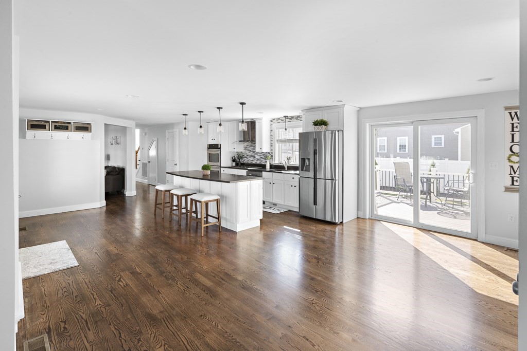 2 Willow Avenue Danvers, MA 01923 - Photo 9 of 42 a living room with stainless steel appliances kitchen island granite countertop furniture and wooden floor