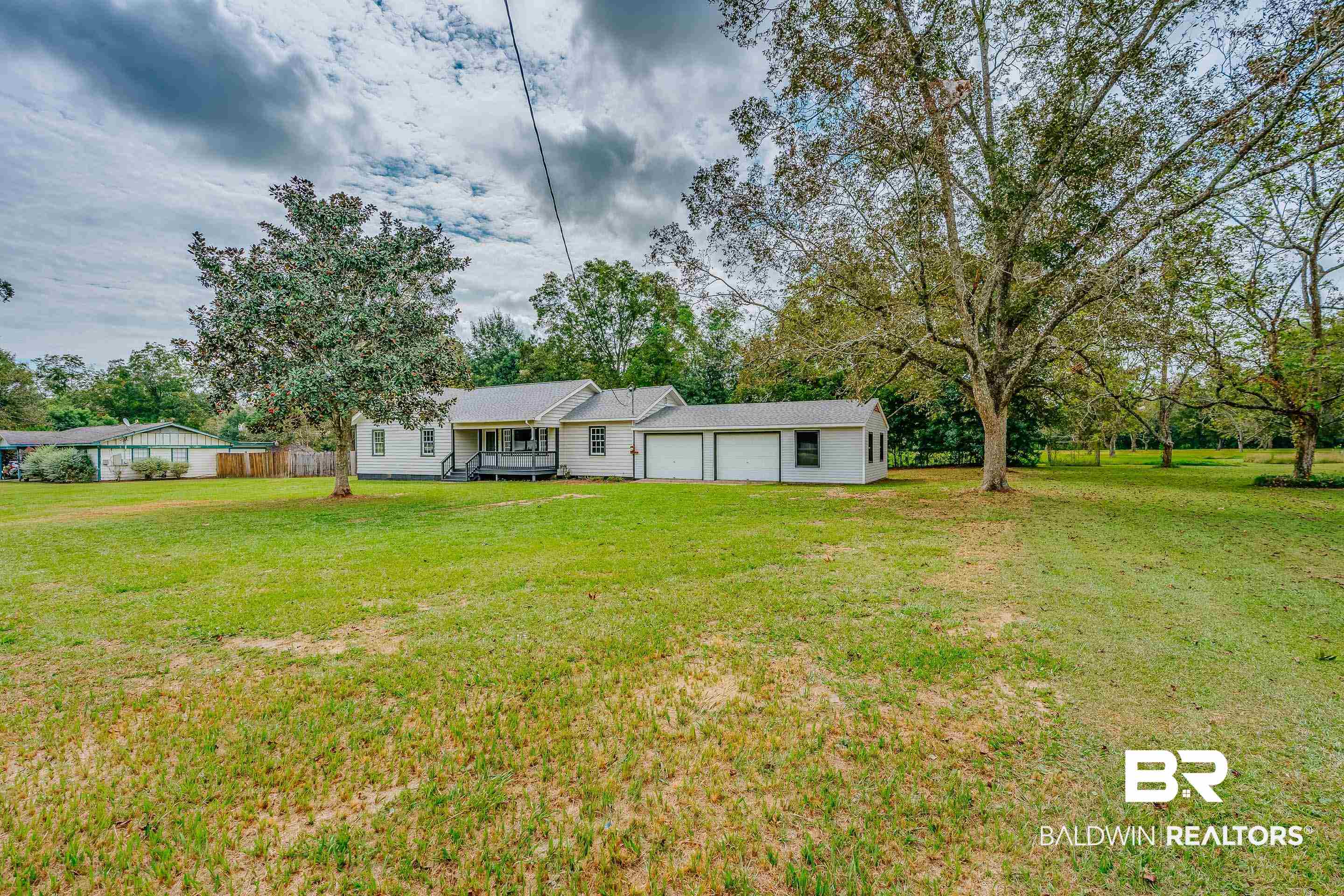8001 16th Street Irvington, AL 36544 - Photo 31 of 35 View of yard featuring an attached garage and view of scattered trees