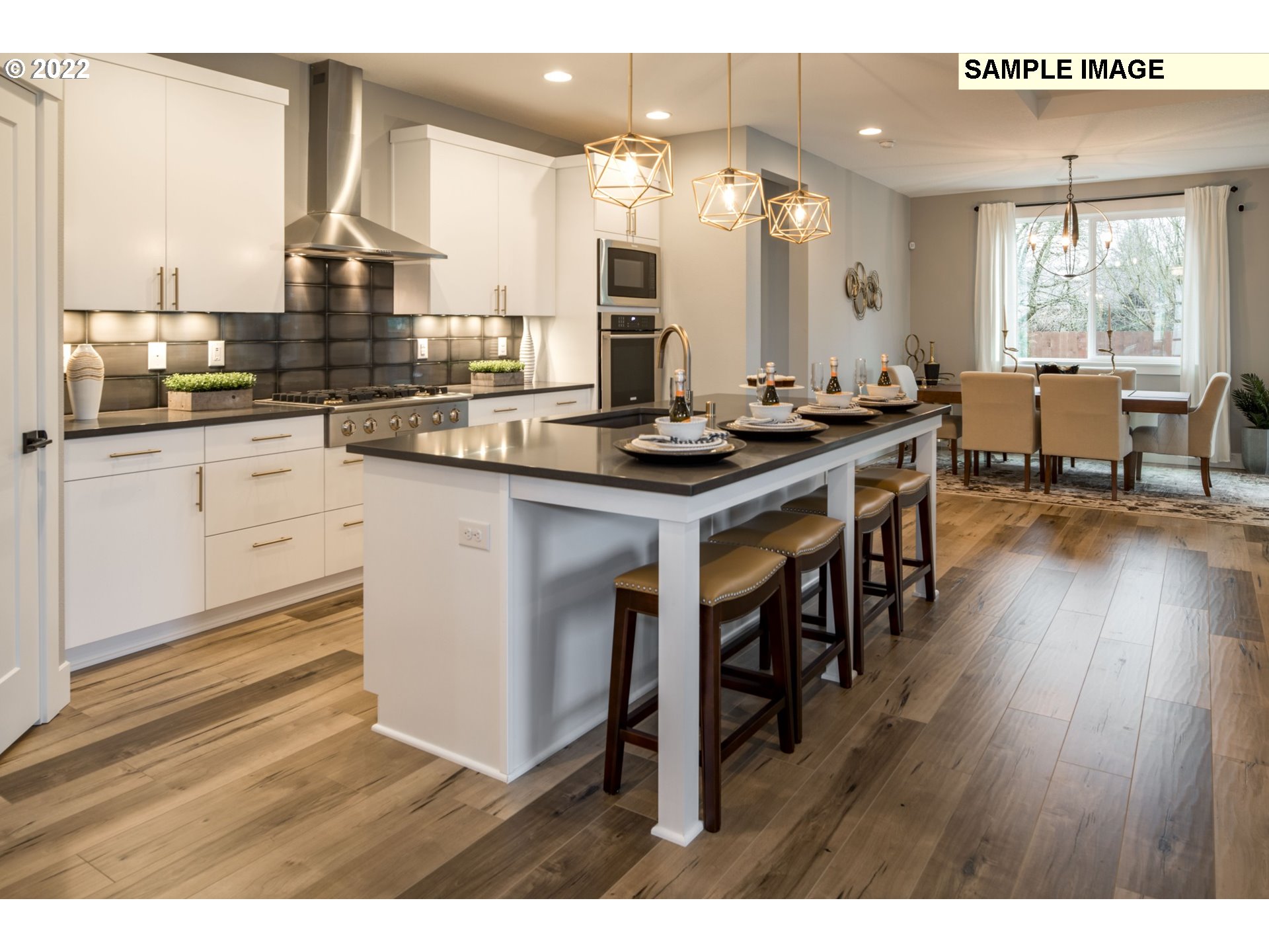 1644 South 51st Place Ridgefield, WA 98642 - Photo 4 of 20 a kitchen with stainless steel appliances granite countertop a stove a sink dishwasher and a dining table with wooden cabinet