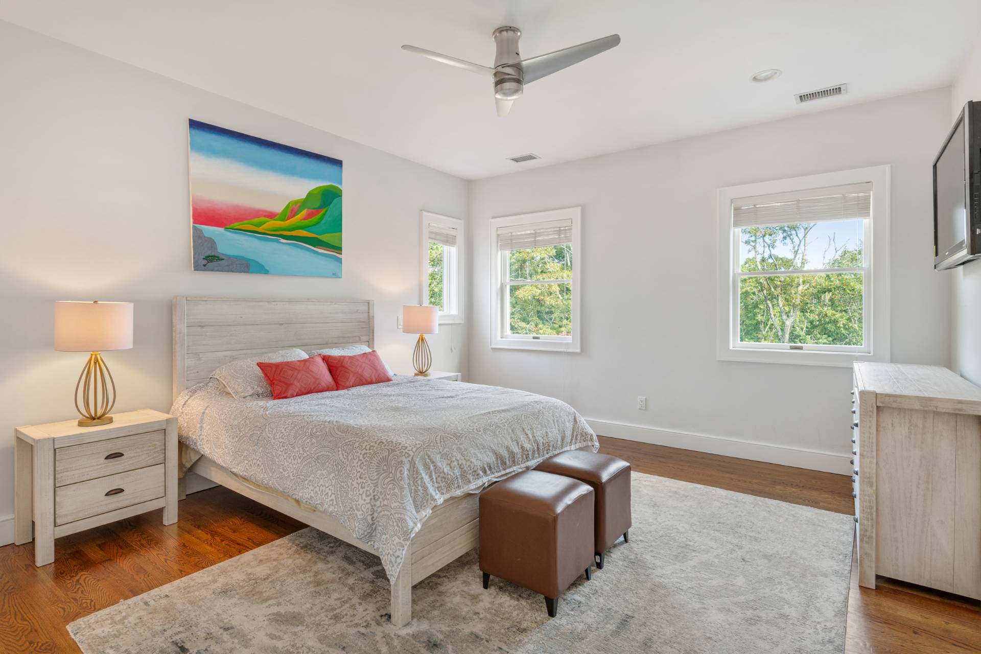 Undisclosed Address Sag Harbor, NY 11963 - Photo 19 of 36 a bedroom with a bed and a painting on the wall