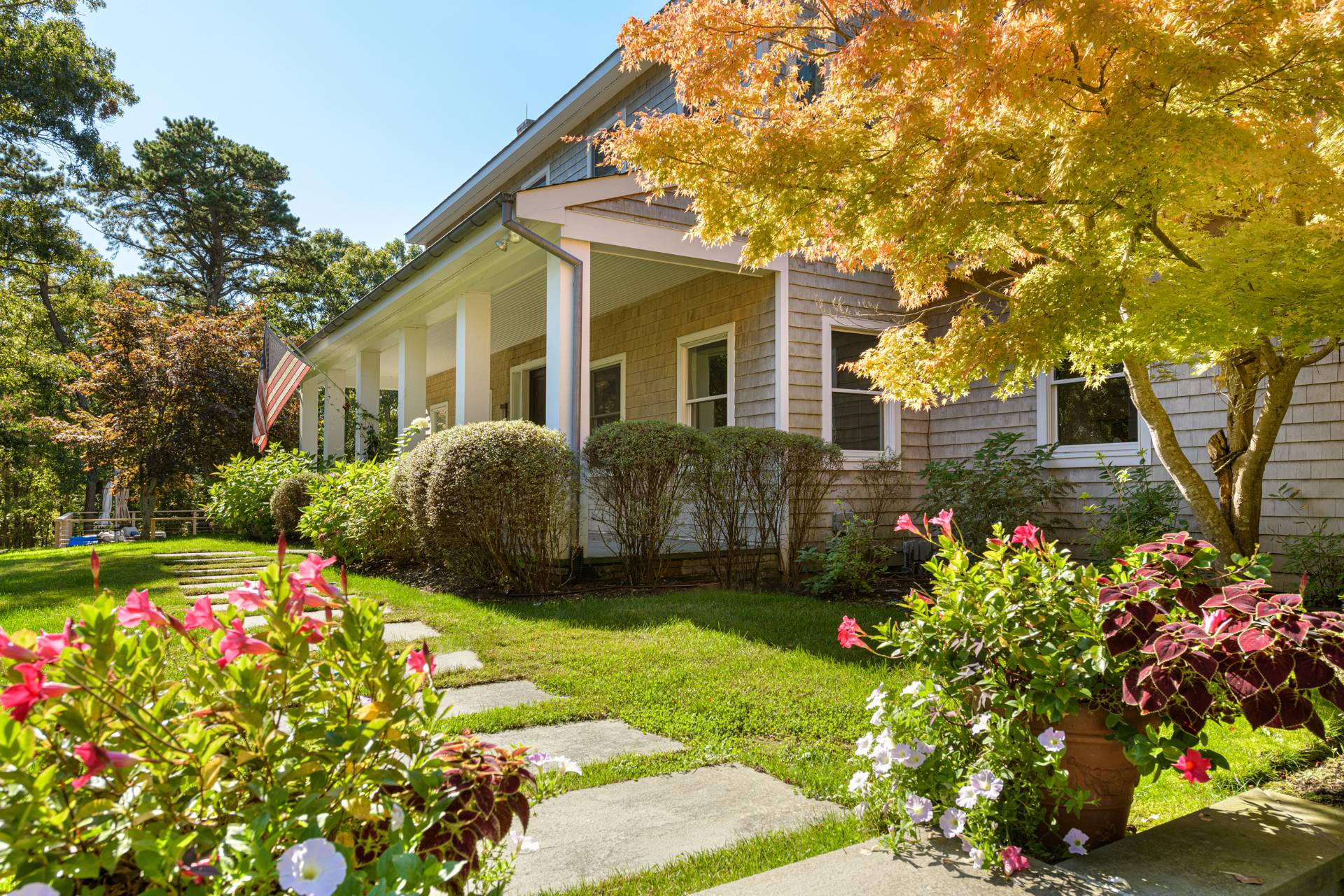 Undisclosed Address Sag Harbor, NY 11963 - Photo 2 of 36 a front view of a house with a yard and fountain