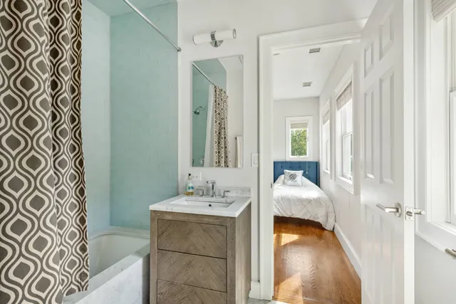 a bedroom with a bed and wooden floor