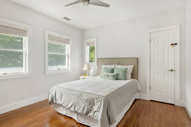 a living room with furniture a rug and a large window