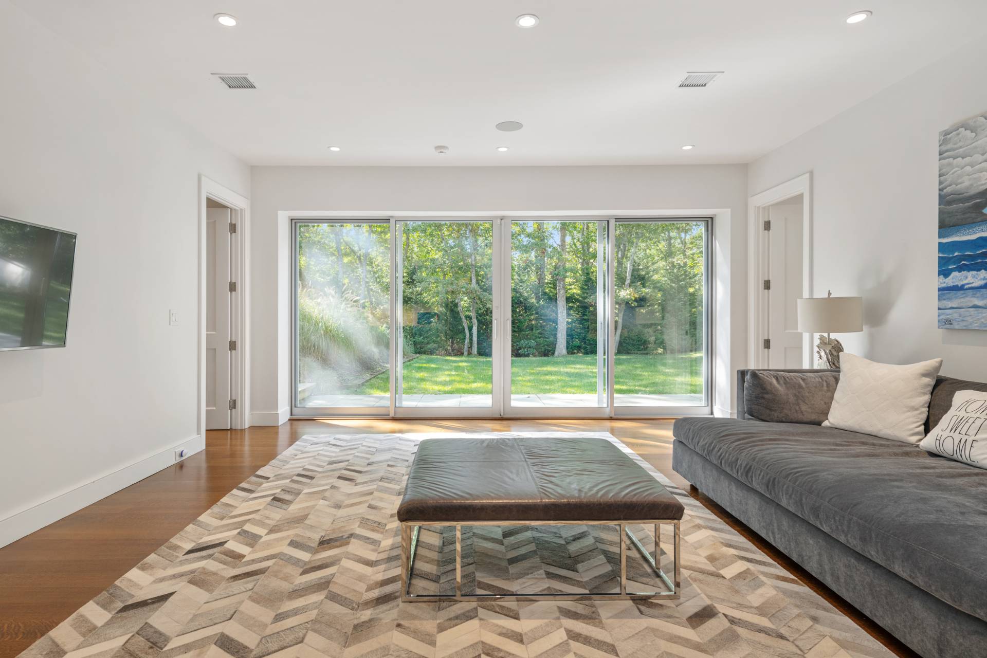 Undisclosed Address Sag Harbor, NY 11963 - Photo 25 of 36 a living room with a couch and large windows